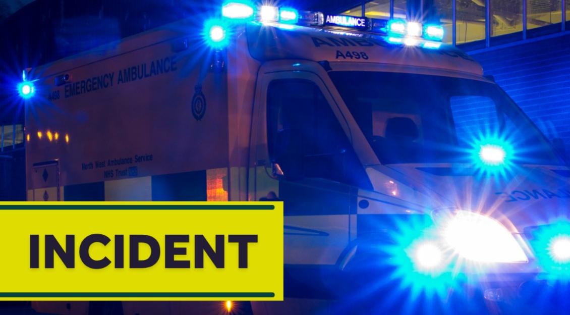 An ambulance with flashing blue lights and the word 'INCIDENT' in a yellow bar.