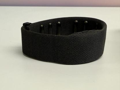 Black fabric headband with small black protrusions.