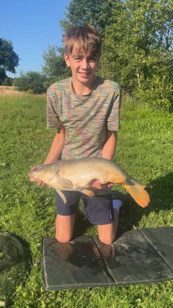Boy holding a large fish.