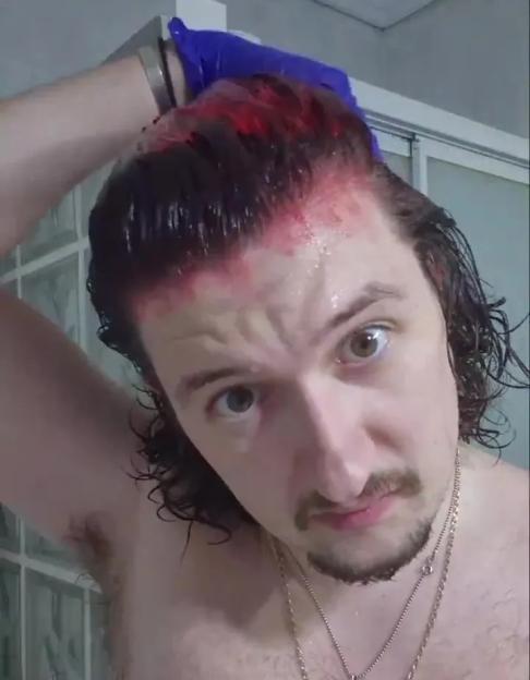 Frank Ilett applying red hair dye to his hair.