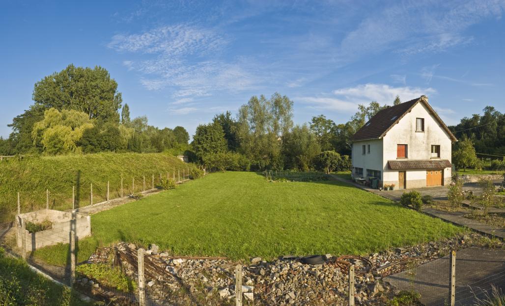 Country house with a large lawn and garden.