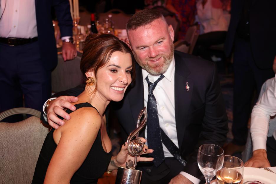 Coleen and Wayne Rooney pose with a music award at the Nordoff Robbins Legends of Football event.
