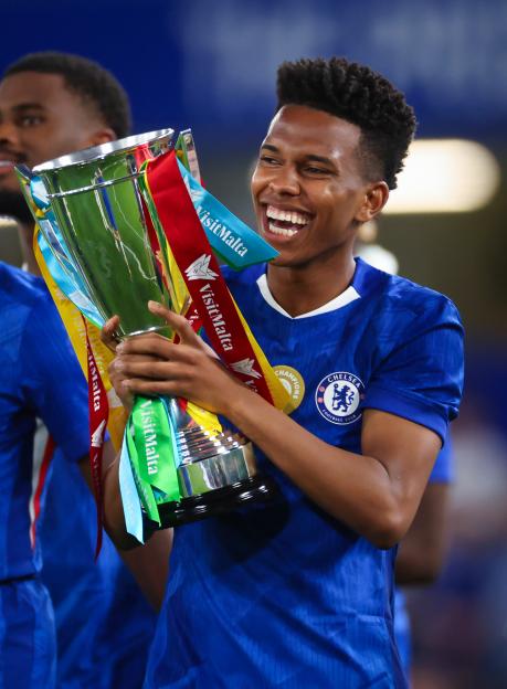 Chelsea player Estevao celebrates with a trophy.