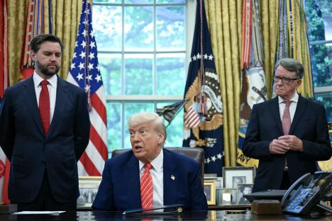 President Trump announcing a trade agreement with Britain, flanked by aides.
