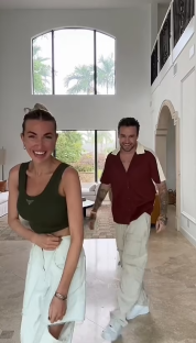 a man and a woman are dancing in a living room