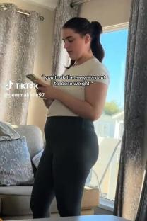 Woman reading a phone message about weight loss.