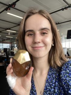 Woman holding perfume bottle.