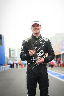 Dan Ticktum holding his third-place trophy at the Tokyo E-Prix.