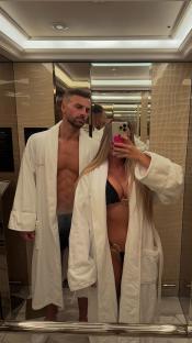 Couple in bathrobes in a hotel elevator.