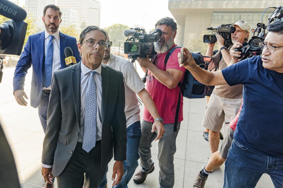 Dr. Mark Chavez and his attorney arriving at a courthouse.