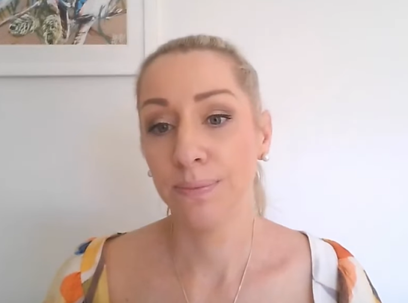 Laura Adlington, a mum-to-be, looking into the camera.