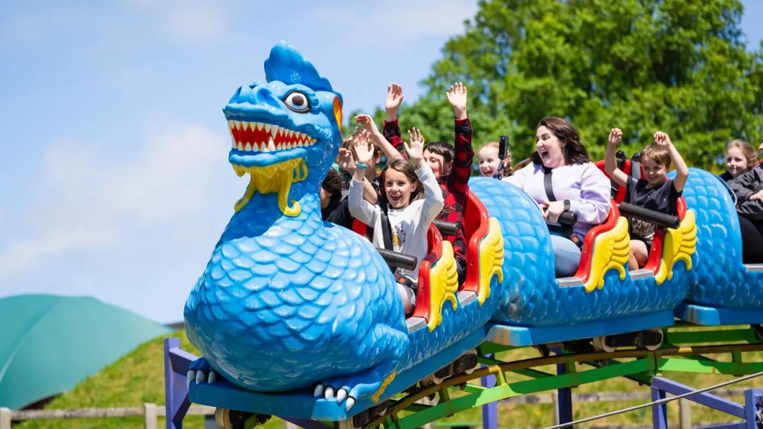 Children enjoying a dragon-shaped ride at Camel Creek Adventure Park.