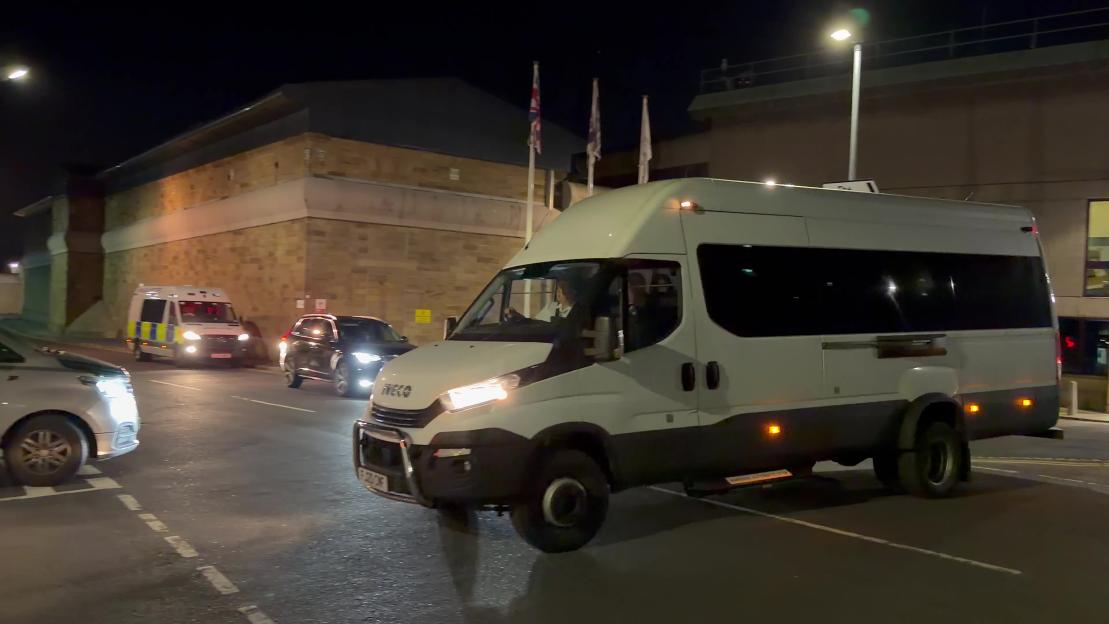 A prison van leaving Wakefield Prison at night.