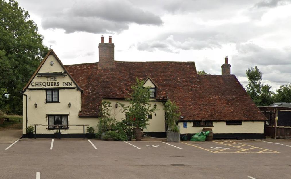 Man wielding crossbow dies after stand-off with police as fire destroys village pub