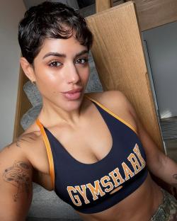Selfie of a woman with short hair wearing a Gymshark sports bra.