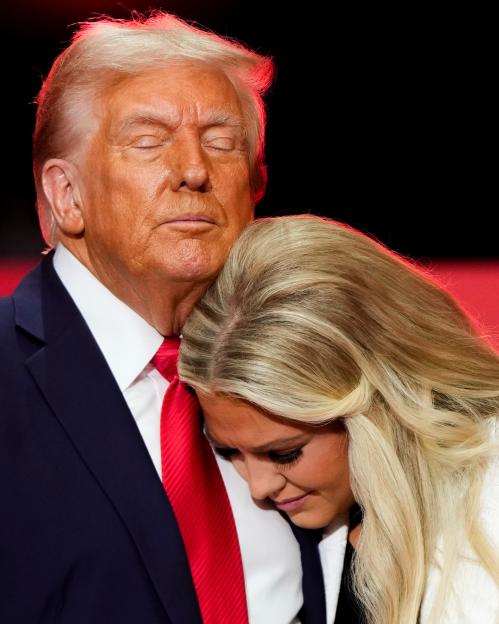 President Donald Trump hugs Erika Kirk at a memorial.