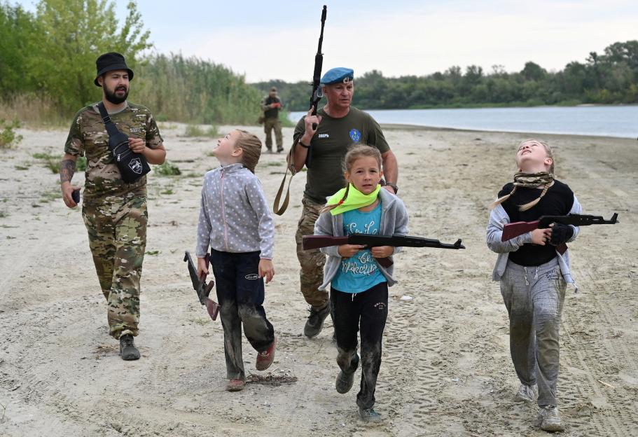 Children with toy guns participate in military training with instructors at the Don Cossack Cadet School in Russia.