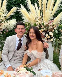 A bride and groom seated together at their wedding reception.