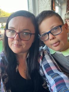 Close-up selfie of a woman and a boy.