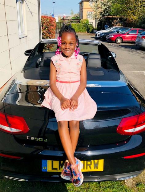 Photo of Shen'iyah Green sitting on the back of a car.