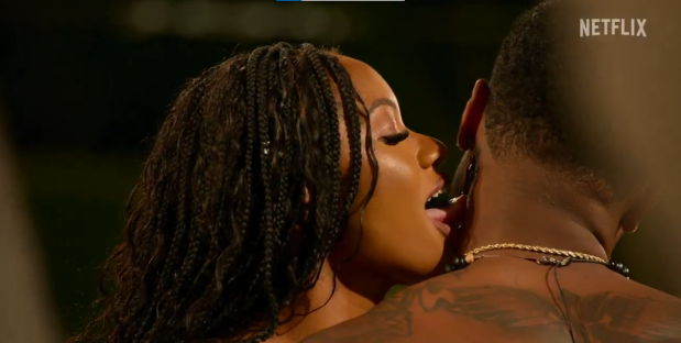 Screenshot from Temptation Island showing a couple kissing.