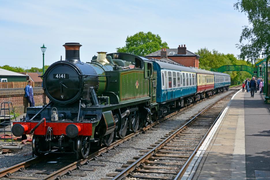 DNR141 Steam tank engine locomotive 4141 & passenger train at platform on Epping and Ongar preserved heritage railway at North Weald station Essex England UK