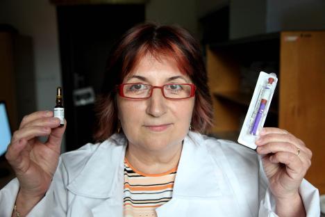 Doctor holding a vial and syringe of anti-androgen medication used for chemical castration.