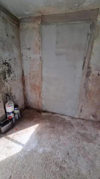 A dirty shed before renovation.