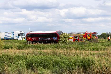 Double-decker bus and car accident scene with emergency services.