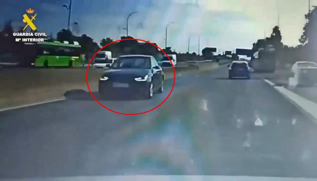 Video still of a car driving the wrong way on a motorway.