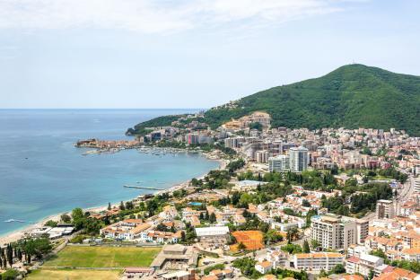 Aerial view of Budva, Montenegro, showing the town, harbor, and coastline.