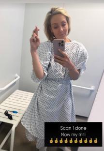 Woman in hospital gown holding phone, caption says