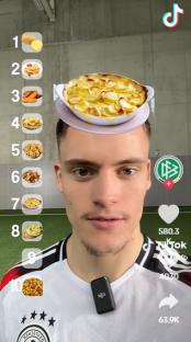 Man with a potato gratin on his head, numbered food choices on the side.