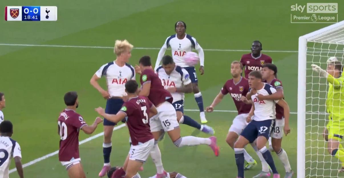 Soccer players vying for the ball near the goal.