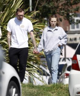 Jeremy Forrest and Jessica Amos holding hands on a street.