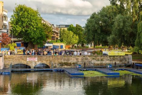 2C4NCGN People in Cambridge enjoy takeaway drinks at the Mill Pond, a week before pubs and restaurants in England will be allowed to reopen after Coronavirus