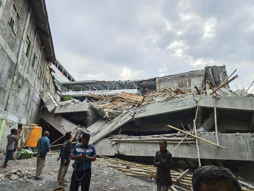 Frantic rescue as school collapses leaving at least one student dead and dozens trapped under the rubble in Indonesia