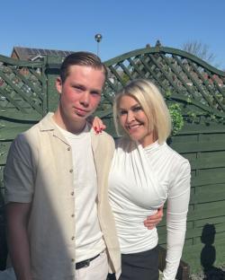 Photo of a mother and son embracing outdoors.