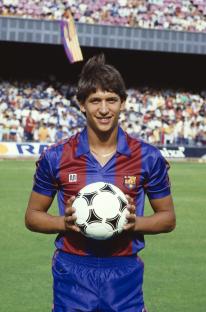 Gary Lineker in an FC Barcelona uniform holding a soccer ball.