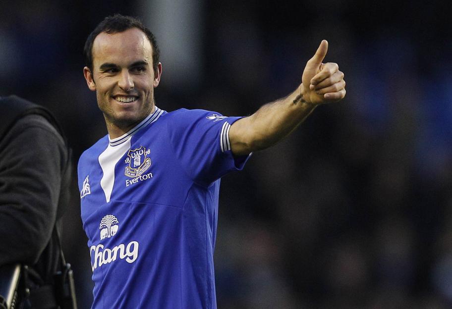 Landon Donovan giving a thumbs up to the crowd while wearing an Everton jersey.