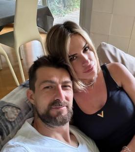 Close-up selfie of a man and woman cuddling.
