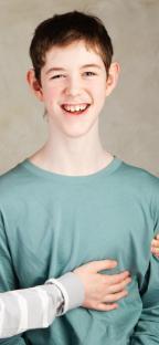 Photo of a smiling autistic teenager.