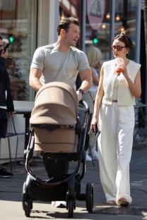 Michelle Keegan and Mark Wright strolling with their baby in a stroller.