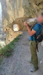 Story from Jam Press (Idiot Throws Rock) Pictured: Video grab - The tourist is seen casting the heavy rock in northern Spain¿s Picos de Europa National Park. VIDEO: Idiot tourist faces ¿168,000 fine for throwing huge rock down gorge in popular park An idiot tourist is facing an eye-watering ¿168,000 fine for throwing a massive rock down a gorge in a popular national park. The young man¿s pal filmed him casting the heavy rock and the video was later uploaded to social media for ¿likes¿. Seconds after the large stone was tossed, a deafening bang was heard as it hit the ground several metres below. The idiotic stunt was filmed at a point along the popular Cares Trail in northern Spain¿s Picos de Europa National Park. Of the park¿s estimated 2m annual visitors, around 300,000 hike the Cares Trail - its most popular walking route. The clip was later shared by a social media account that features videos of young people throwing rocks into voids. Although most clips on the page get a handful of views, this one blew up and quickly caught the police¿s attention. The Spanish Civil Guard have since announced that they are investigating the young man¿s antics, as reported by NeedToKnow. A spokesperson said: ¿This stunt could cost you dearly. ¿Throwing this rock could land this person with a fine ranging from ¿5,001 to ¿200,000. ¿Why? Because disturbing the environment in the Picos de Europa National Park is classed as a very serious offence. ¿Keep that in mind when visiting a national park - these are specially protected areas due to their high environmental value.¿ Javier said: ¿There are livestock farmers who pass through down there. Your little joke could¿ve ended badly.¿ Another viewer said: ¿You have to be a real idiot - you could¿ve gone down with the rock. The force and weight of that boulder could¿ve smashed someone to pieces.¿ A third said: ¿There¿s an alternative path underneath - I just hope no one was down there. And let¿s not forget, people go canyoning or climbing in those areas - when you throw something, there could be someone below.¿ A fourth said: ¿He should be accompanied by a responsible adult - it¿s clear he¿s not ready to be out on his own.¿ And a fifth said: ¿In the mountains, you mustn¿t throw rocks if you can¿t see where they¿ll land - you have no idea who might be below. You could hit a person or an animal.¿ ENDS EDITOR¿S NOTES: Quotations have been translated to English. Video Usage Licence:(EMERGENCY SERVICES) We have obtained this material directly from the emergency services (fire / police / ambulance / rescue workers). Video Restrictions: None.
