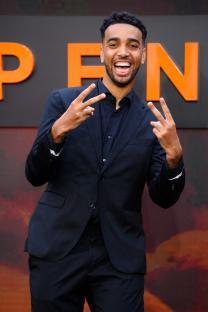 Niko Omilana at the Oppenheimer UK premiere, giving a peace sign.