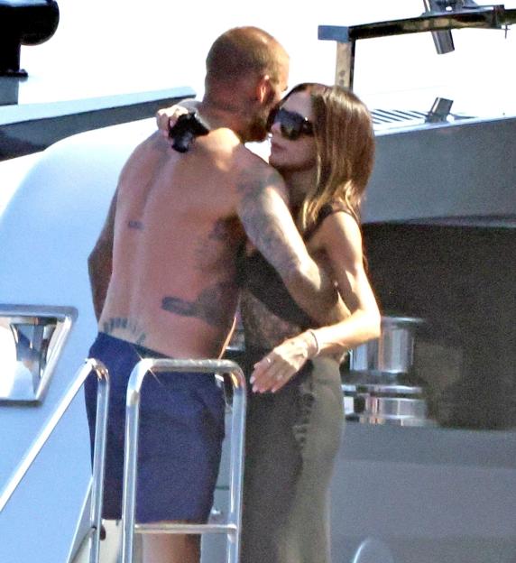 David and Victoria Beckham on a yacht.