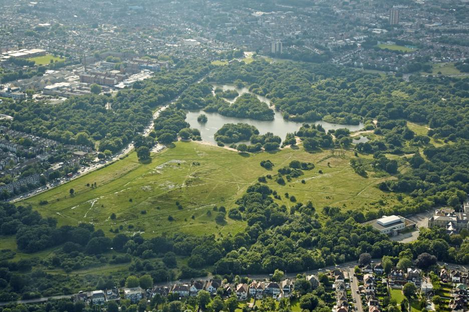 Aerial view of Epping Forest, Wanstead, and Whipps Cross in East London, with housing, forests, and bodies of water.