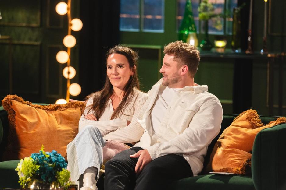 Ashley and Grace from MAFS sitting together on a green couch with orange pillows.