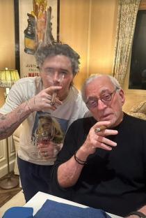 Brooklyn Beckham and Nicola Peltz's father-in-law smoking cigars.