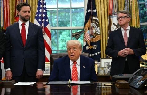 President Trump making a trade announcement with aides in the Oval Office.